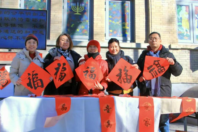 Believers held the square-paper "Fu" characters during the distribution event of the Spring Festival couplets at Chongwenmen Church in Beijing on January 19, 2025.