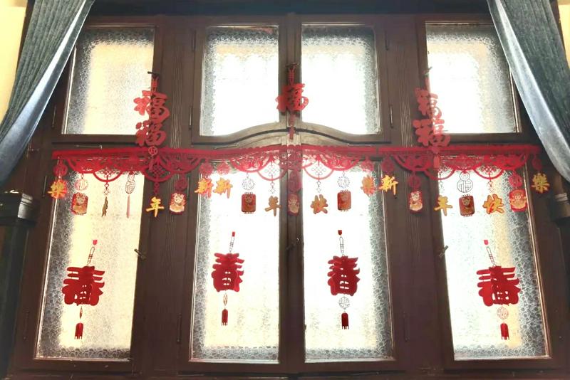 During the Spring Festival, paper-cuts for window decorations are displayed on the windows of the church at Qingdao Municipal CC&TSPM in Shandong Province.