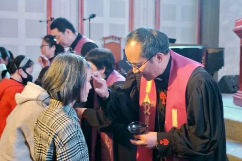 A pastor drew upon a believer's forehead in the sign of the cross with ashes during the Ash Wednesday worship service held at Agape Church in Chongqing City on March 5, 2025.