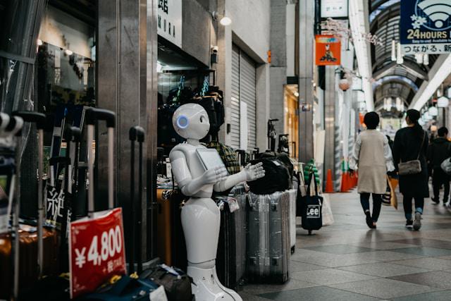 A robot stands near luggage bags.
