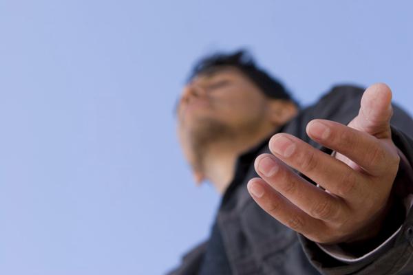 A man prays to God. 