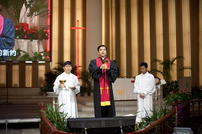 Rev. Yang presides the communion service for the baptized members