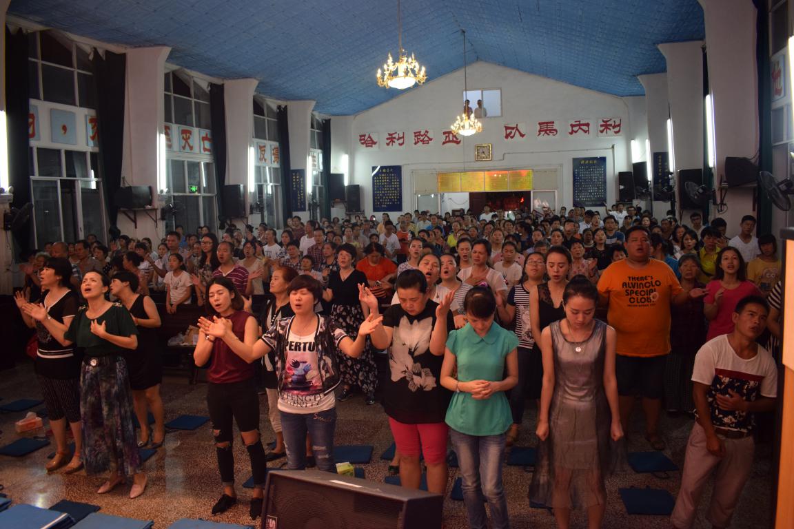 The congregation of a Chinese church prays together 