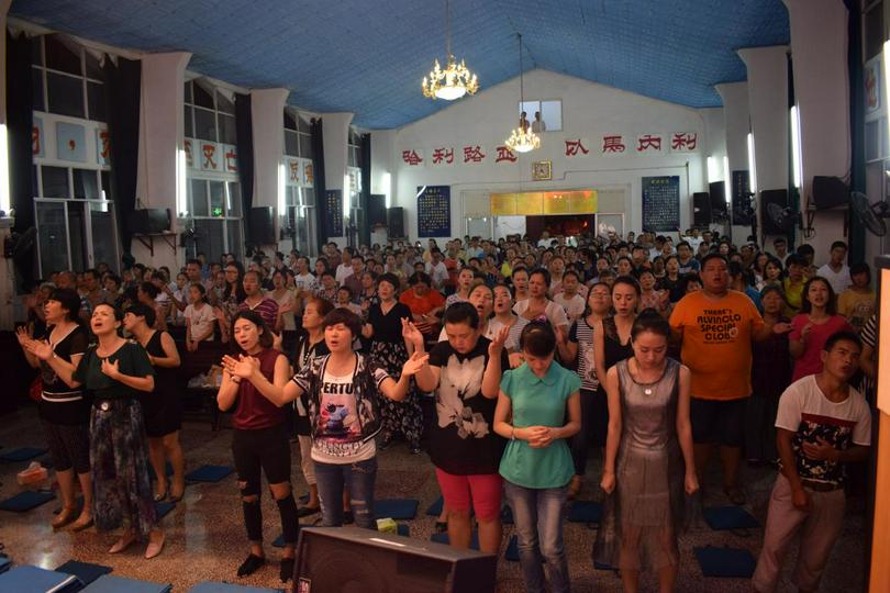 The congregation of a Chinese church prays together 