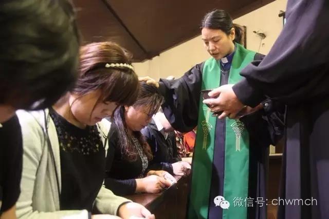 Rev. Liu Cuimin, the senior pastor, baptizes the catechumens