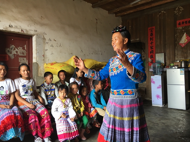 A leader of a church choir of Miao people leads the believers to sing hymns