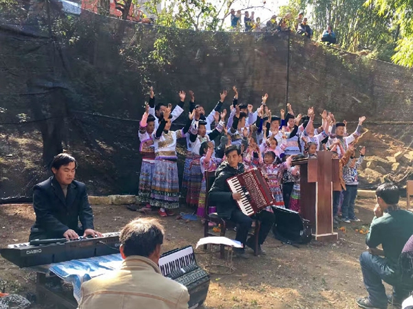 The Miao choir sings hymns to praise God and some brothers play instruments 