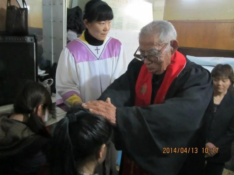Elder Huang prayed for a believer on April 13, 2014