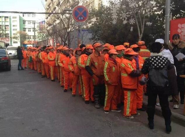 The urban sanitation workers wait in line to get boxed lunch