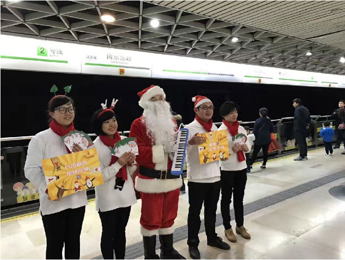 Members of the fund send questionnaires and gifts to pedestrians in a subway station