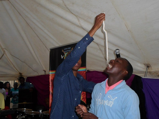 A South Africa pastor puts a white snake into the mouth of a believer (credit:anticult.kaiwind.com)
