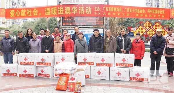 The fifteen poor families receive boxes of food and clothes
