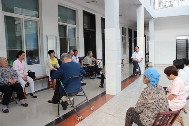 Some seniors and nurses sing hymns and praise together 