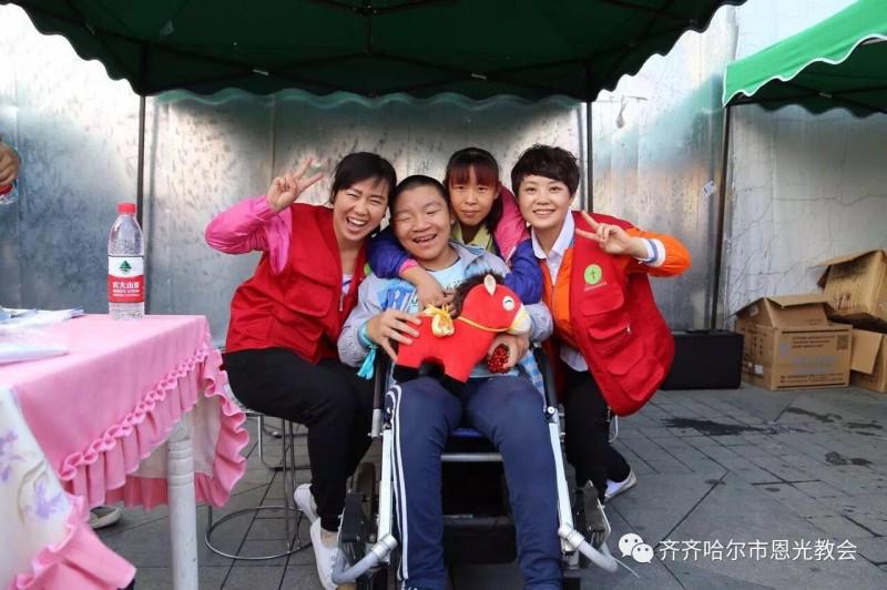 The volunteers and a boy with cerebral palsy who is supported