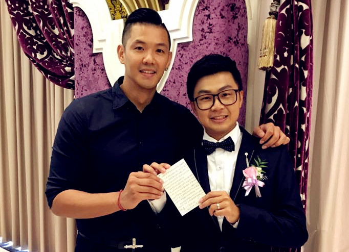 Blackie Chen (left) and  Li Jiajun, the bridegroom, held the letter