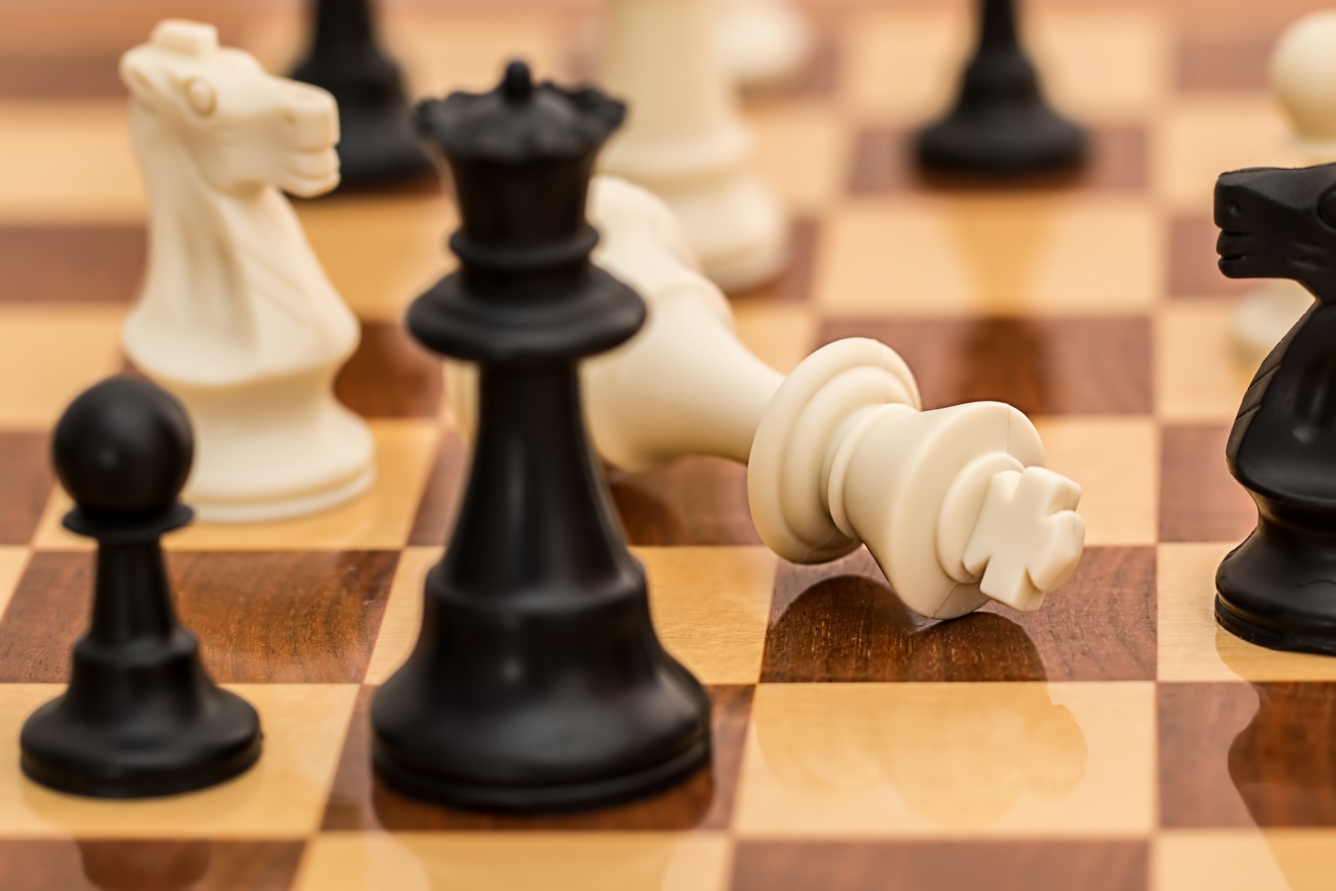 A white chessman falls on the chessboard.