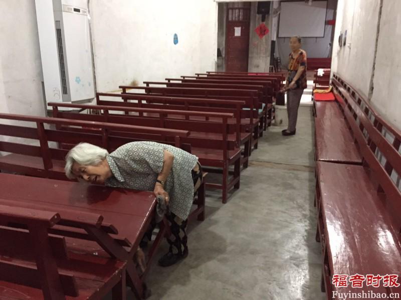 Several elderly sisters clean the church. 