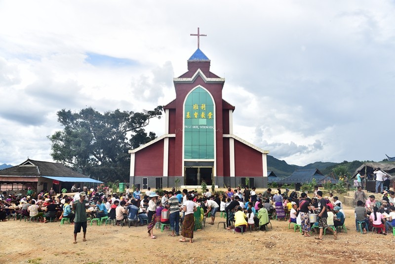 Thanksgiving day of Laku people Christians eat together in the church yard.