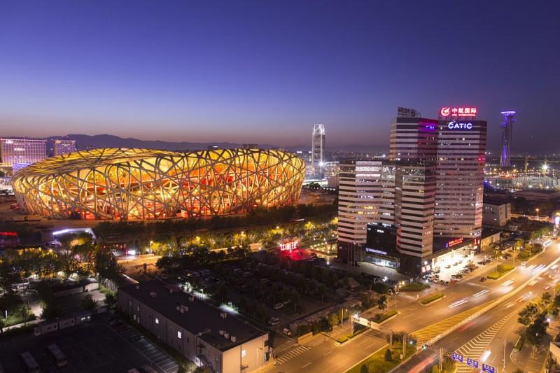 Evening scene: The National Stadium or Bird's Nest (left)