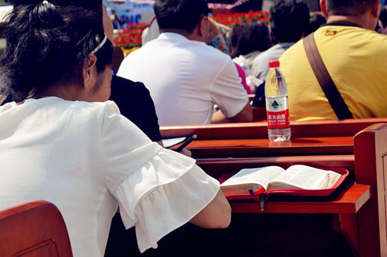 A young girl takes notes when attending a church service.