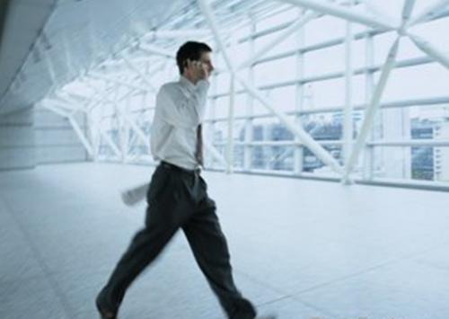 A busy man receive a phone call in the workplace. 