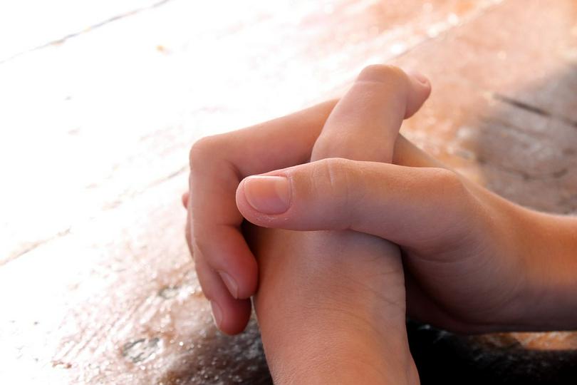 A woman prays to God