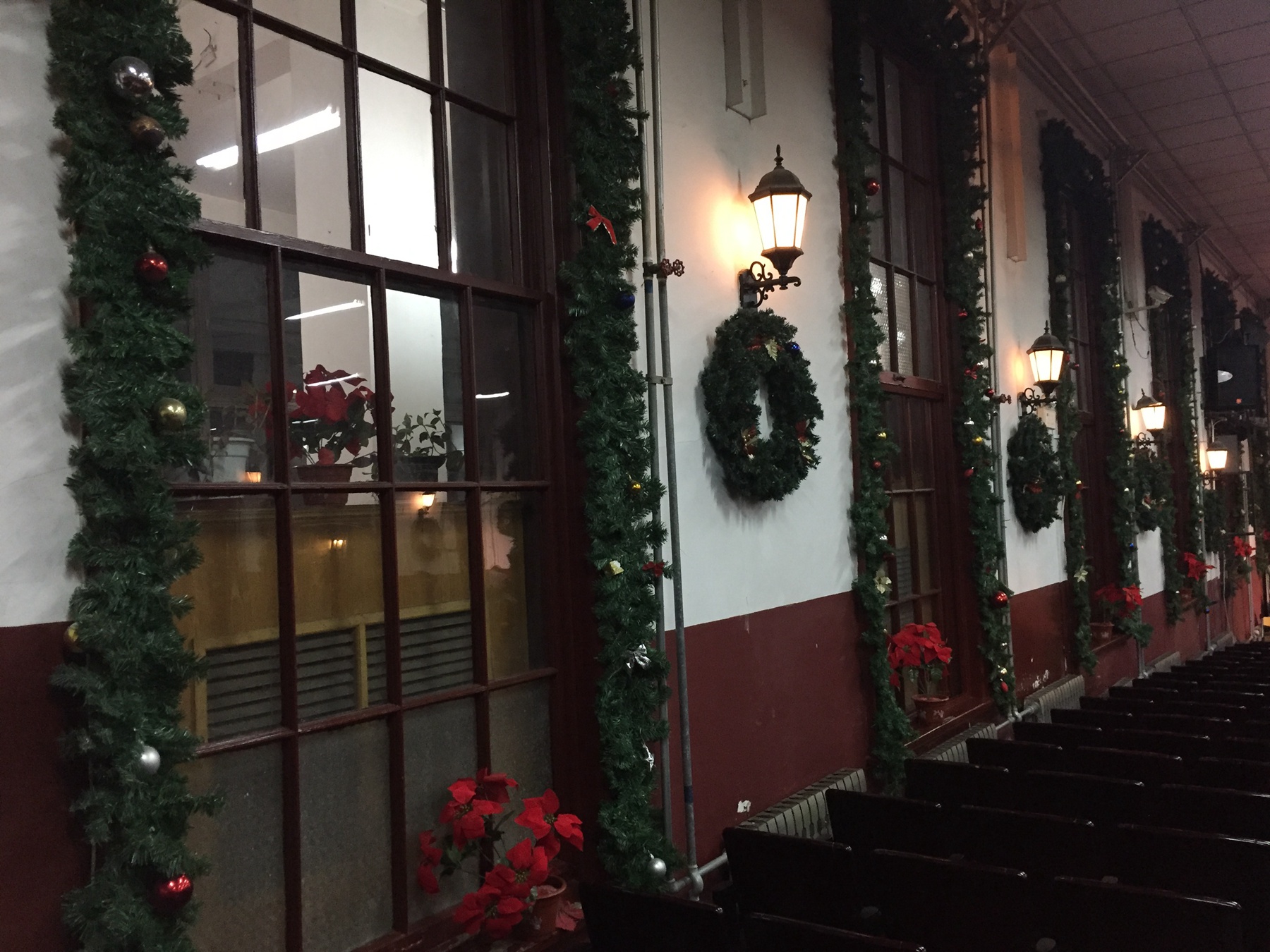 Wreaths and pine branches were hung on the church wall.