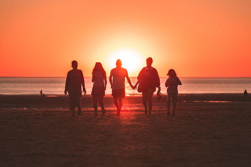 A family have fun on the beach. 