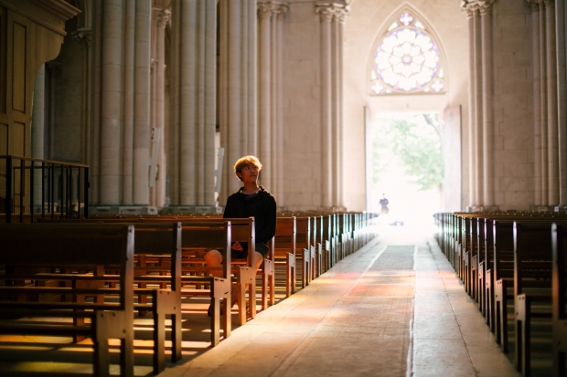 A believer sits in a church. 