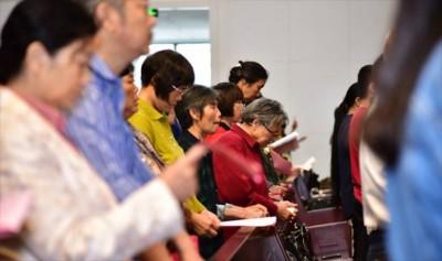 Chinese Christians read the Bible in a church. 