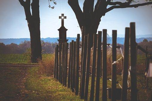 A cross stands on the wayside.