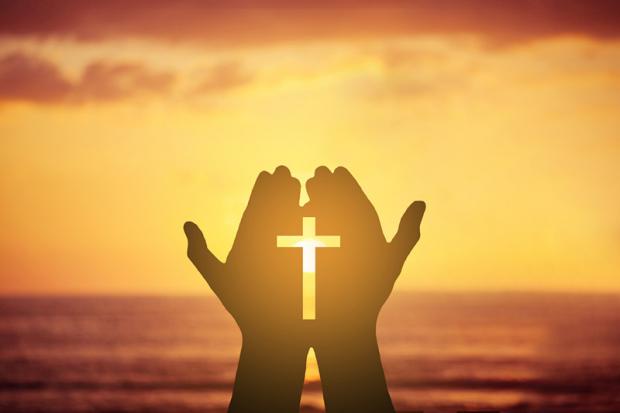 The cross in the hands.