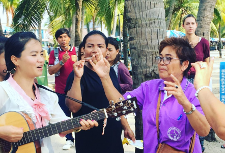 Pastor Fon of Zion MB Church, Khao Sam Muk, Thailand, plays guitar for the communion event on the beach.