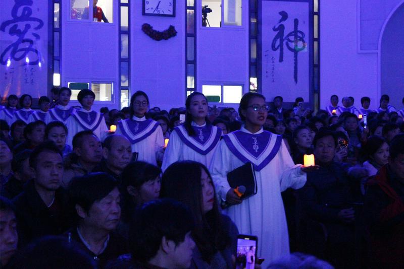 The choir walked into the hall of Beijing Fengtai Church with candles in their hands on Dec. 24, 2018.