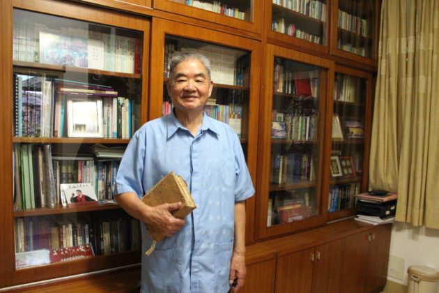 Rev Chen Yiping, 89, at his study room holding the Bible that accompanied him during his 20 years of corrective labour from 1958-78.