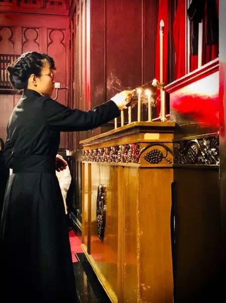 An acolyte extinguished one of the candles in the Tenebrae conducted in Shanghai Community Fellowship on Good Friday. 
