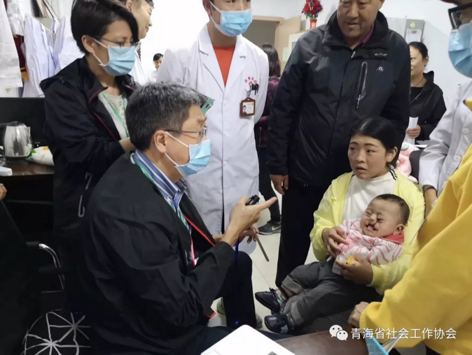 A doctor from HK Cornerstone Association examined a boy with a cleft lip before the surgery on April 21, 2019. 