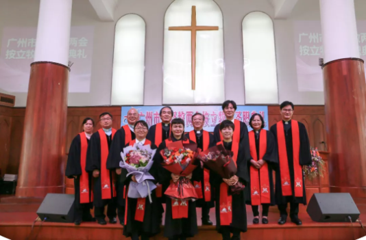Group photo of three newly ordained pastors and other church leaders