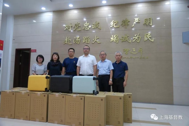 Firemen squadron of the Bund in Shanghai receiving gifts from Shanghai's Pure Heart Church on Aug 14, 2019. 