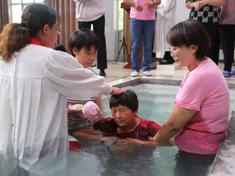 A woman was baptized by immersion in Zhuen Church, Aug 25, 2019. 