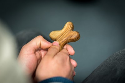 A man holds a cross in his hands. 