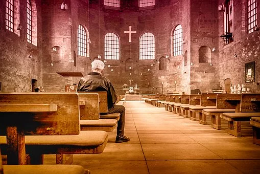 A man sits in a church.