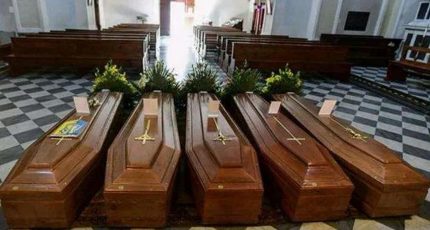 Coffins are laid in an Italy church. 