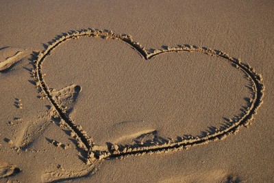 A love heart drawn on the sand. 