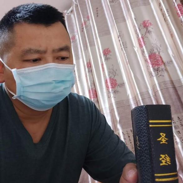 Brother Tian held the Bible he bought at the church where he walked into in early 2020. 