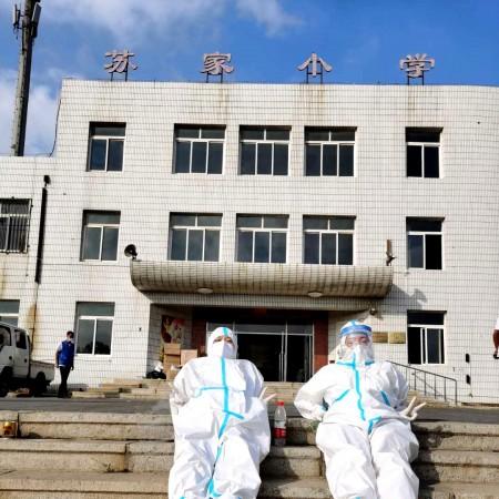 Ju Wanzhen and her sister lied on a concrete staircase to ease the tired body by the sunlight, in July 2020, due to the new cluster outbreak in China's coastal city Dalian.