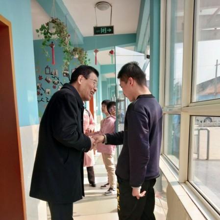 Elder Fan Kexiao from the church in Fufeng County talked with the disabled child in Xinyue Handicapped Children’s Center in Jiangzhang Town, China's northern Shaanxi Province on November 10, 2020.