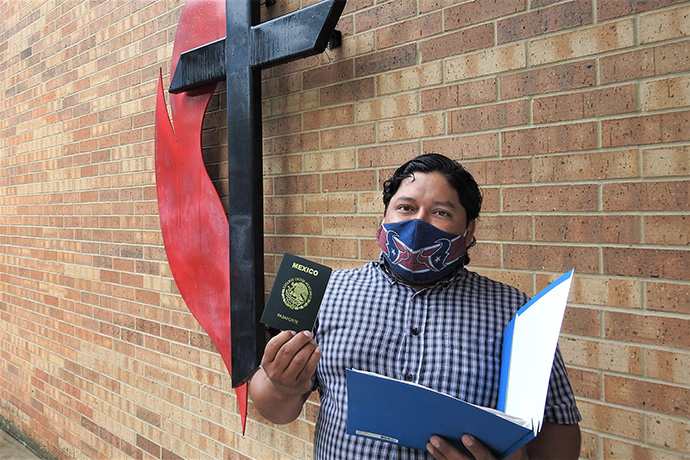 Juan Martinez shows off his renewed Mexican passport outside Kingwood United Methodist Church in northeast Houston. 