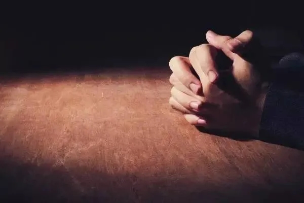 Hands are put together to pray.