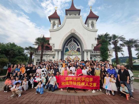 Fifteen disabled and 20 Christian families took a group picture before a western church inside Xuanwu Lake, Nanjing, Jiangsu, on May 15, 2021.